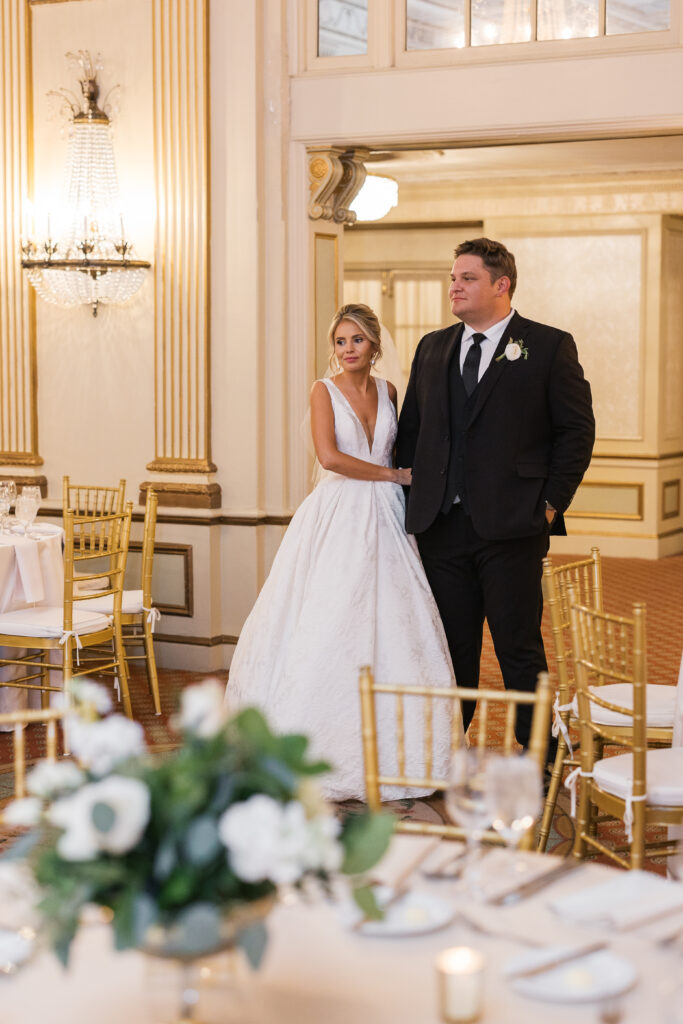A bride and groom are looking at their reception space for the first time at The Brown Hotel. The couple is looking at the elevated wedding reception space in admiration. 