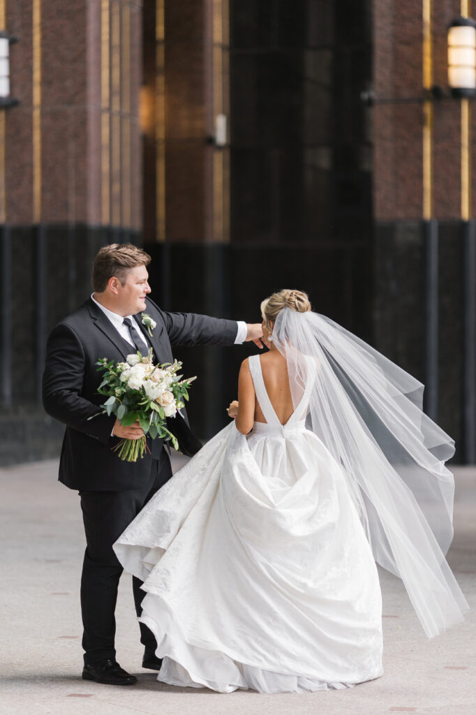 A bride and groom in a timeless and true to color wedding photo. The photo was taken in downtown louisville near their venue, The Brown Hotel. 